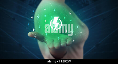 Hand in suit holding lightning bolt on his hand, green environment concept  Stock Photo