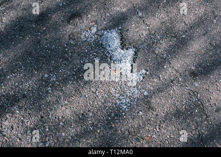 Broken glass fragments on asphalt. Broken car glass after an accident Stock Photo