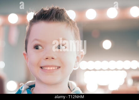 Small happy caucasian boy is smiling after hair cut Stock Photo