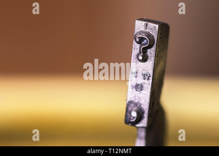 Macrophotography of typewriter hammers with question mark. Stock Photo
