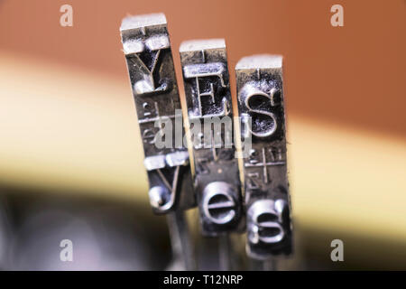 Macrophotography of typewriter hammers with YES word Stock Photo