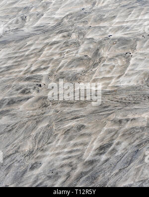 Sedimentary fluid sand flows/, Mars-like water fluvial ridge patterns on a tidal beach. For 'go with the flow', movement, landscape just like Mars Stock Photo