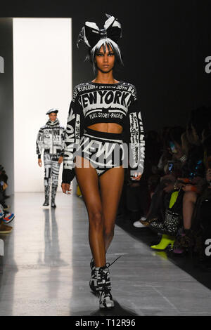 Model Aiden Curtiss walks on the runway during the Moschino Fashion
