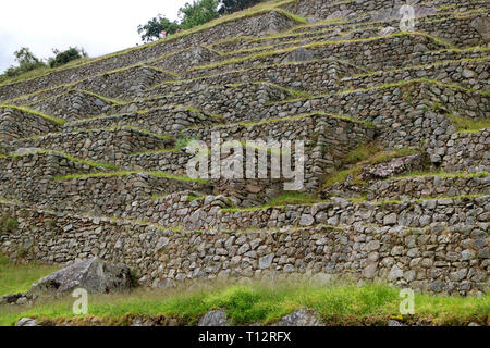 Remains of the Incas Agricultural Terraces on the Hillside of Machu Picchu, Archaeological Site in Cusco Region, Peru Stock Photo
