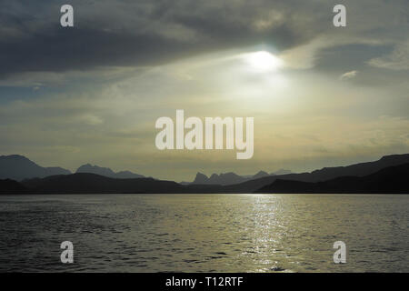 Sun on the background of mountains and the sea. Fjords of the Musandam Peninsula. Khasab bay. Oman Stock Photo