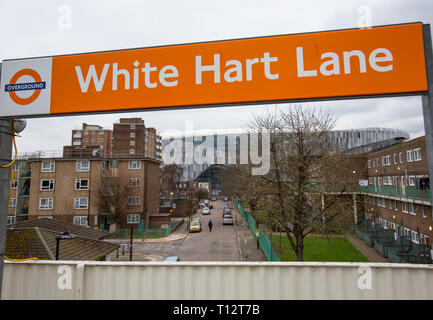 White Hart Lane overground station sign with Tottenham Hotspur Stadium in the distance at High Road (White Hart Lane), London, England on 19 March 201 Stock Photo