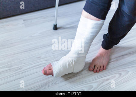 walking on crutches with a leg in a cast Stock Photo