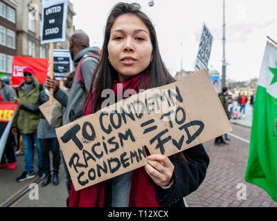 A woman is seen holding a placard against the far right political party FvD during the demonstration. Thousands of people gathered at the Dam square in the center of Amsterdam to demonstrate against racism and discrimination. They ask for diversity and solidarity, against all forms of racism and discrimination. Also, against the two political far-right parties in The Netherlands, the PVV and the FvD which have increased their power during the last elections in the country. A small far-right group showed up during the walk holding two big placards and shouting at the demonstrators. Stock Photo