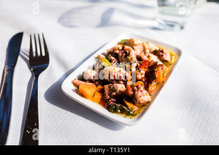 Mmm, fresh grilled octopus salad as an appetizer at a seaside outdoor cafe for lunch in Thessaloniki, Greece. Stock Photo