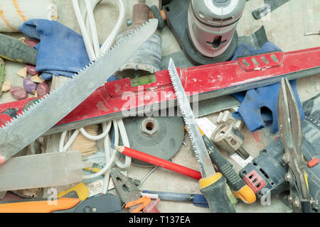 old dirty construction tools scattered on the table Stock Photo