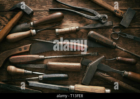 Three Antique Woodworking Chisels Isolated On Wooden Bench Grunge