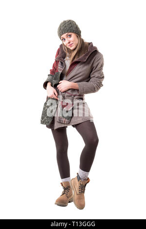 Cute charming young woman wearing boots, beanie cap and warm winter coat. Full body isolated on white background. Stock Photo