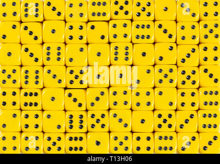 Background pattern of 70 yellow dices, random ordered Stock Photo