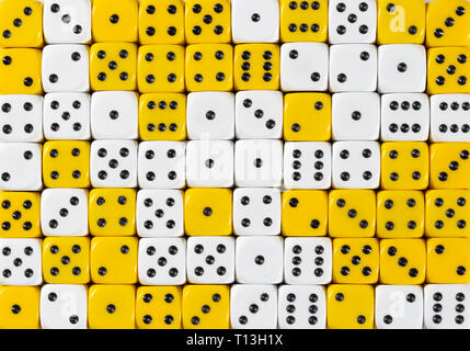 Background of 70 random ordered white and yellow dices Stock Photo