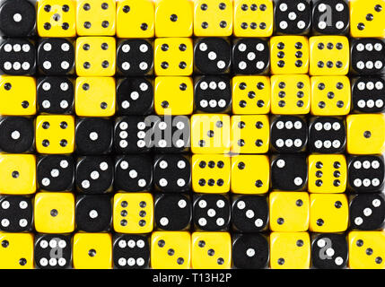 Background of 70 random ordered black and yellow dices Stock Photo