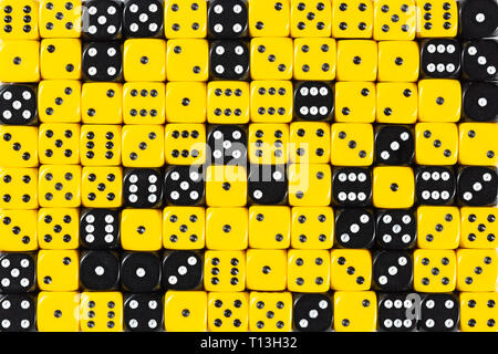 Background patteren of random ordered yellow and black dices Stock Photo