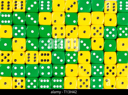 Background of 70 random ordered yellow and green dices Stock Photo