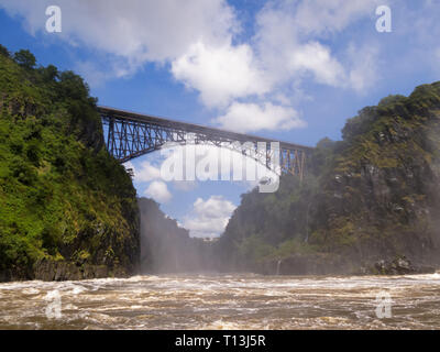 High bridge over rapidly flowing river gorge on sunny day Stock Photo