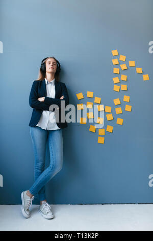 young businesswoman wearing headphones in her office Stock Photo - Alamy