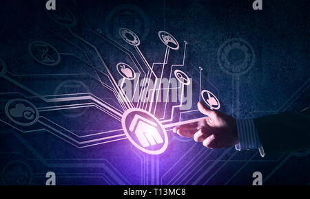 Close of businessman hand showing at user interface glowing on wall Stock Photo