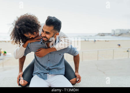 Spain, Barcelona, happy couple having fun on the beach Stock Photo