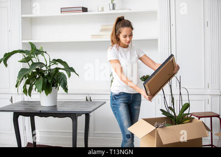 Woman packing cardboard boxes Stock Photo