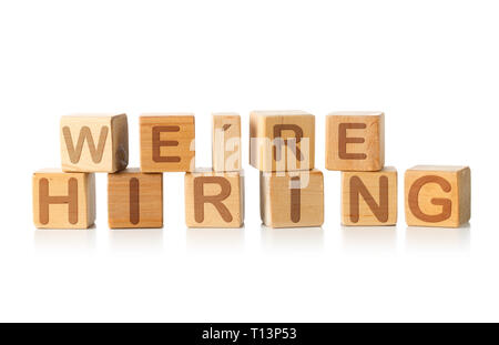 We're Hiring written on wooden cube blocks on white background - human resources or job vacancy concept Stock Photo