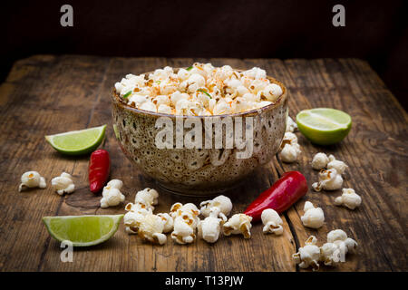 Bowl of popcorn flavoured with chili and lime Stock Photo