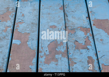 Detail of old wooden boards painted in light blue with several layers of shelled paint Stock Photo