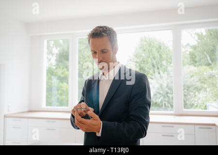 Businessman using glass touch screen in a new home Stock Photo