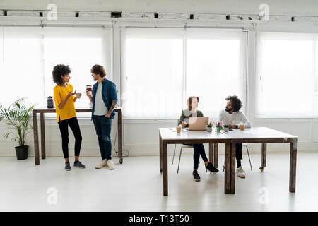 Young business people working together in coworking space Stock Photo