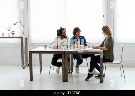 Young creative professionals working together in a cowrking space Stock Photo