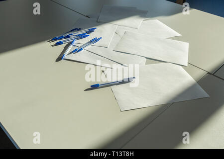 Blank papers and pens on a desk, close up Stock Photo