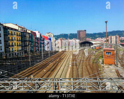 Aerial view of Tran station and rails of train in Basque country against cityscape and mountains Stock Photo