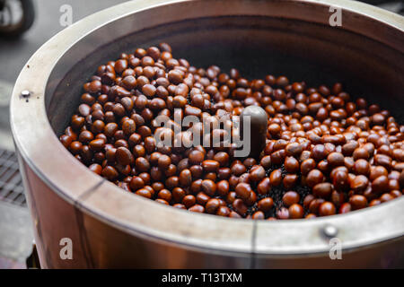 Roasting Brown Chestnuts In Big Pot At Local Street Market Stock Photo