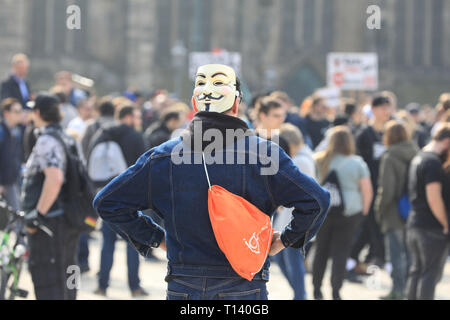 Magdeburg, Germany. 23rd Mar, 2019. A man with a mask takes part in the demonstration against upload filters on the occasion of the planned EU copyright reform. Shortly before the decisive vote on the reform of copyright in the EU Parliament, thousands in Europe protested against the project. Opponents of the reform and especially of the controversial Article 13 had announced demonstrations in about 20 countries. Credit: Peter Gercke/dpa-Zentralbild/dpa/Alamy Live News Stock Photo