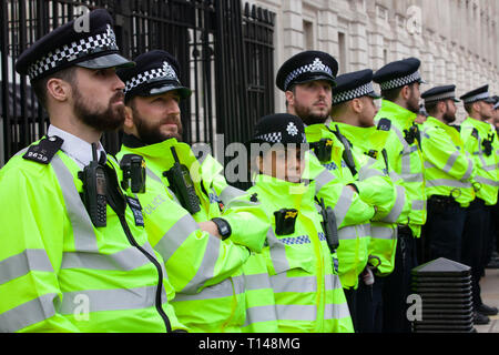 London, UK. 23rd March, 2019. The People's Vote March in London: police guard the gates of Downing Street on Whitehall as protesters passed by, often booing. Credit: Anna Watson/Alamy Live News Stock Photo