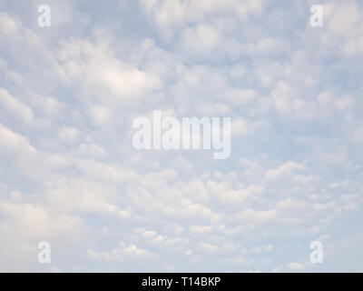 Bright blue sky with many small cirrus clouds - light blue sky background. Stock Photo