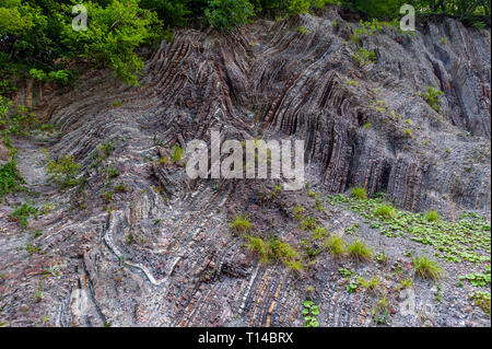 Russia, Krasnodar region, the road to Sochi. The bizarre geometry of the Caucasus Mountains. Multi-colored layers of slate limestone. Stock Photo