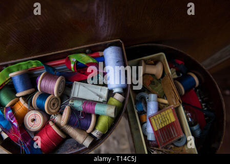Spools of threads of different colors are in box Stock Photo