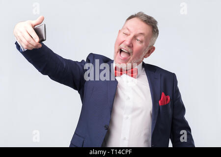 Senior man making a selfie by phone Stock Photo