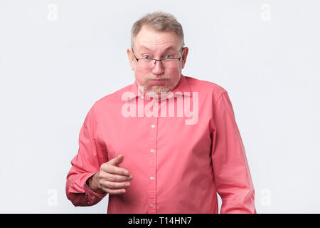 Man grimacing, inflating cheeks, holding breath. Studio shoot Stock Photo