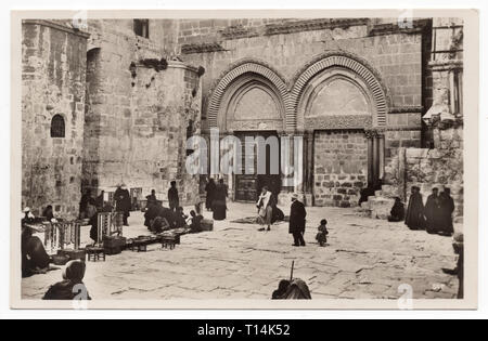 Entrance to the Church of the Holy Sepulchre in Jerusalem depicted in the undated vintage postcard. Courtesy of the Azoor Postcard Collection. Stock Photo
