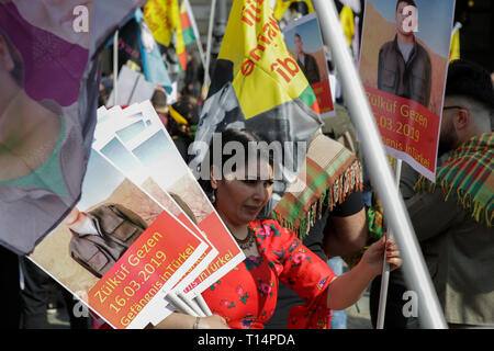 Frankfurt, Germany. 23rd Mar, 2019. A woman distributes posters ahead of the march. Several thousand Kurds marched through Frankfurt, to celebrate Nawroz, the Kurdish New Year's festival. It was the central celebration for Germany and was held under the motto “Free Abdullah Ocalan”, the leader of the PKK (Kurdistan Workers' Party). Credit: Michael Debets/Pacific Press/Alamy Live News Stock Photo