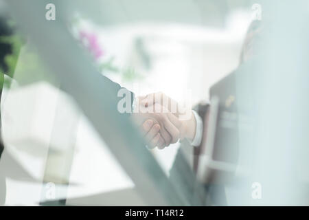 business background.blurred image of business partners shaking hands Stock Photo