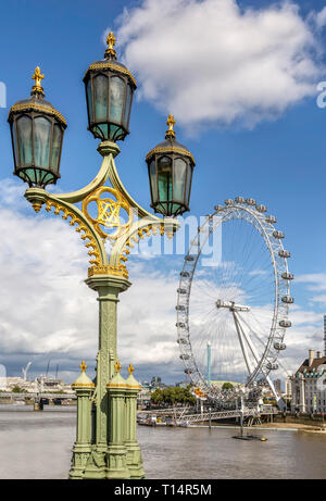 Ancient lamp on Westminster Bridge, London Eye in the distance. Stock Photo