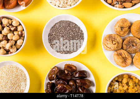 Top view the set of Superfoods in Bowls on yellow Background. Stock Photo