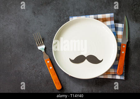 Happy fathers day concept. Table setting - plate, cutlery and napkin on grey stone table. Copy space. Stock Photo