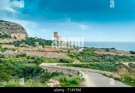 Malta: Scenic road to Ghar Lapsi tower with hilly landscape and sea Stock Photo