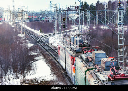 Long freight train approaches to the station. Stock Photo